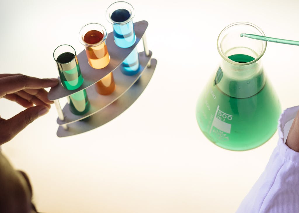 Crop laboratory technician examining interaction of chemicals in practical test modern lab